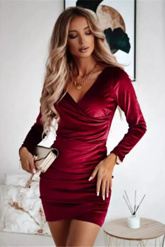 Black Nia wrap dress with V-neck and long sleeves by Lumina Vancouver, styled as a sleek mini dress for elegant occasions.
