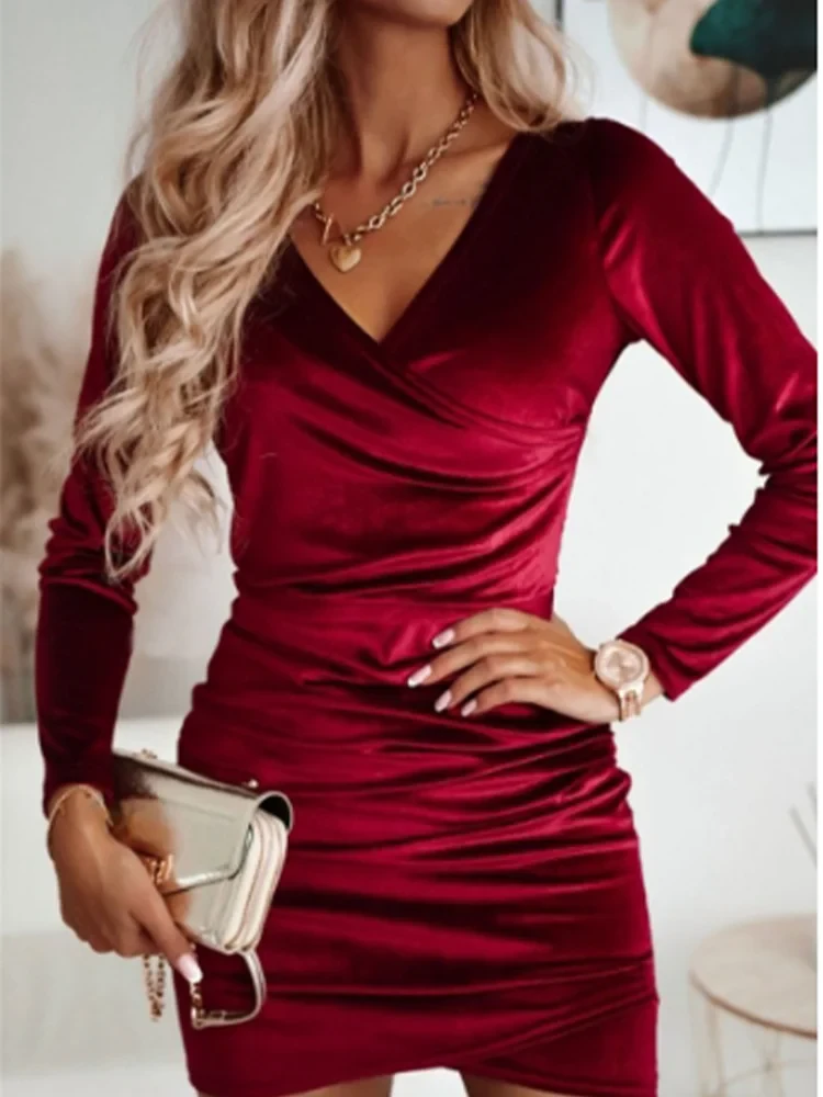 Black Nia wrap dress with V-neck and long sleeves from Lumina Vancouver, showcasing a stylish mini dress design.