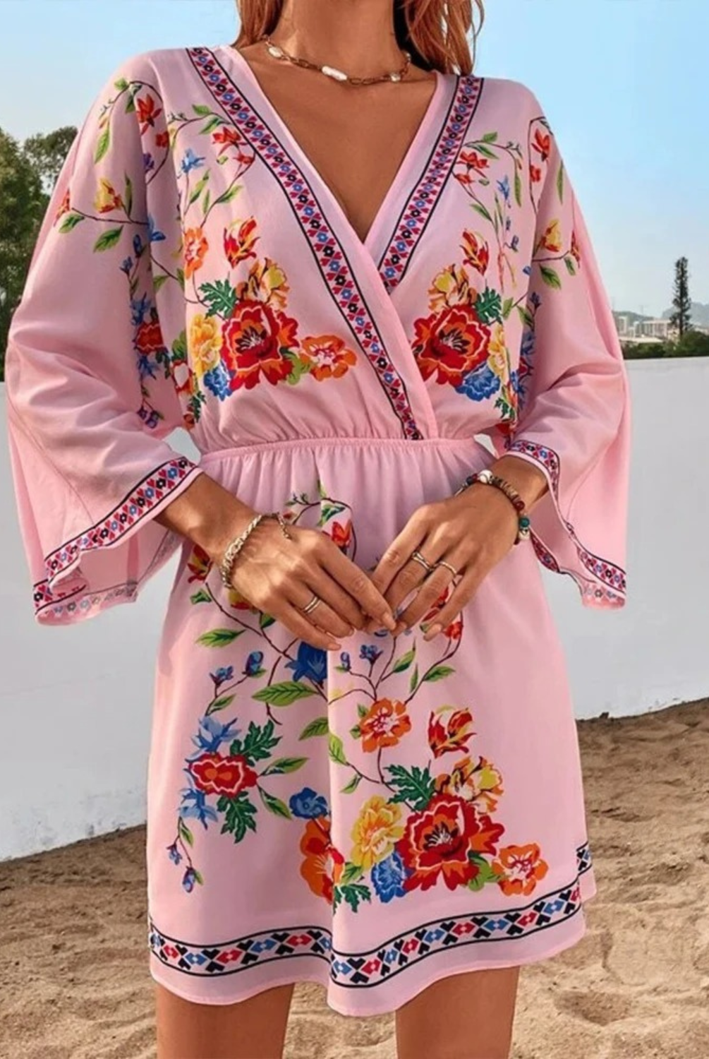 Pink and red floral print V-neck mini dress by Lumina Wear, featuring a stylish and feminine design perfect for casual or dressy occasions.