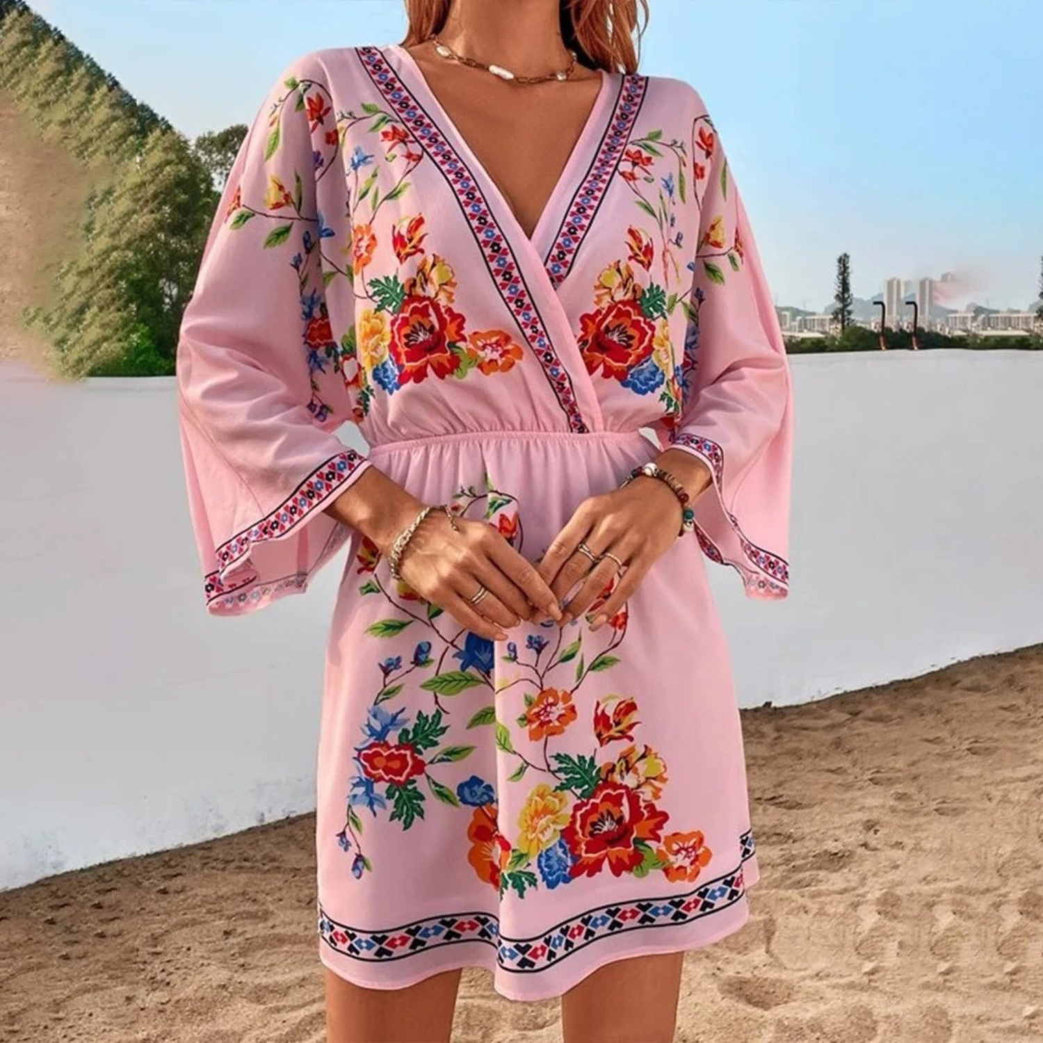 Pink and red floral print V-neck mini dress by Lumina Vancouver, featuring a fitted silhouette and short sleeves.