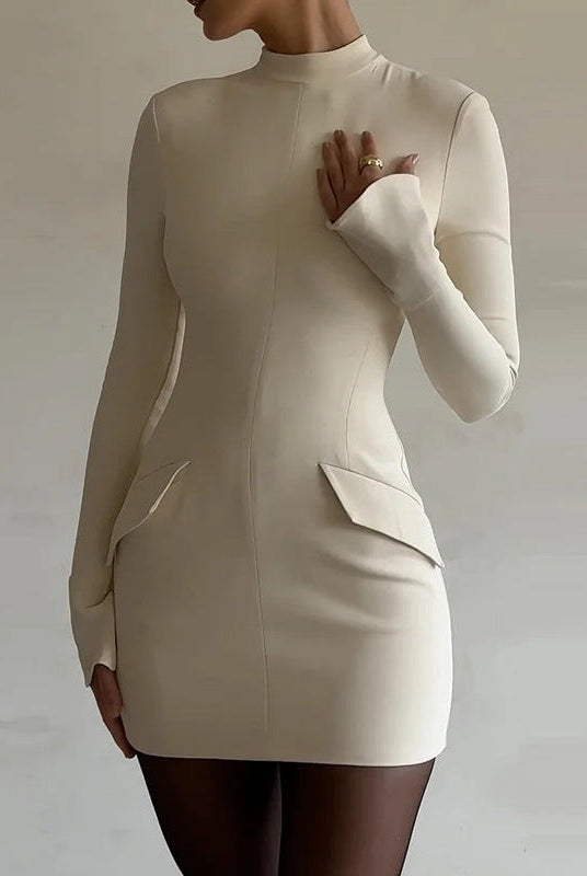 Lumina Wear Ophira mini dress with high neck and long sleeves in milky white, shown on a model.