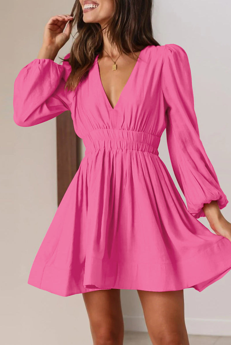 Black Nova mini dress by Lumina Vancouver featuring a V-neckline and puff sleeves, displayed on a model.