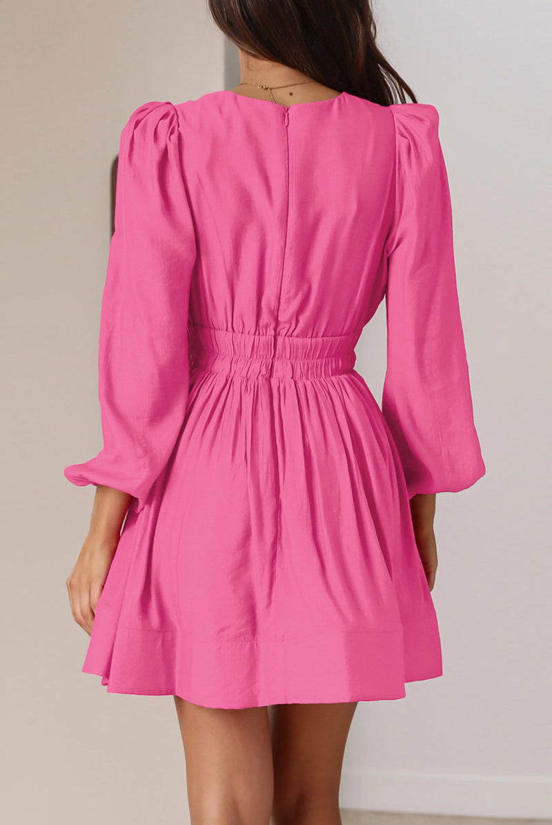 Black Nova mini dress by Lumina Vancouver with V-neck and puff sleeves, shown on a model.