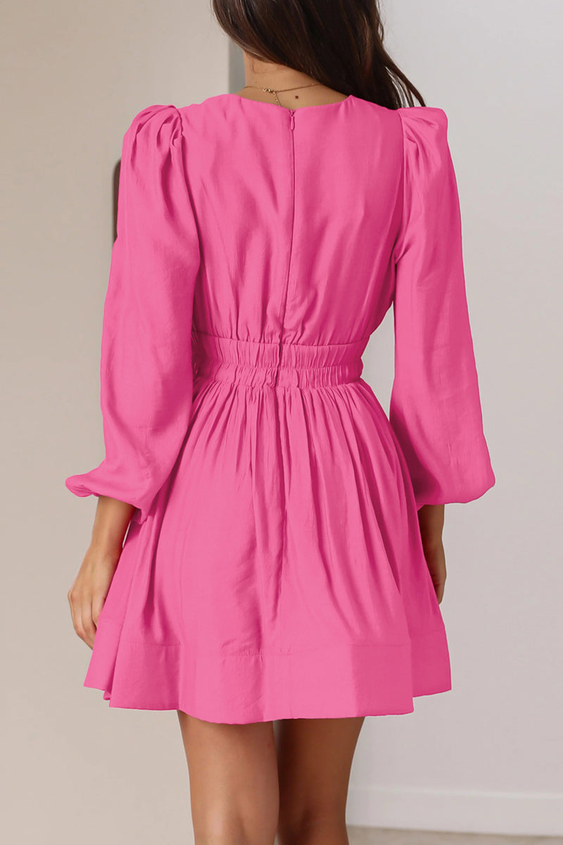 Black Nova mini dress by Lumina Vancouver with V-neck and puff sleeves, shown on a model.