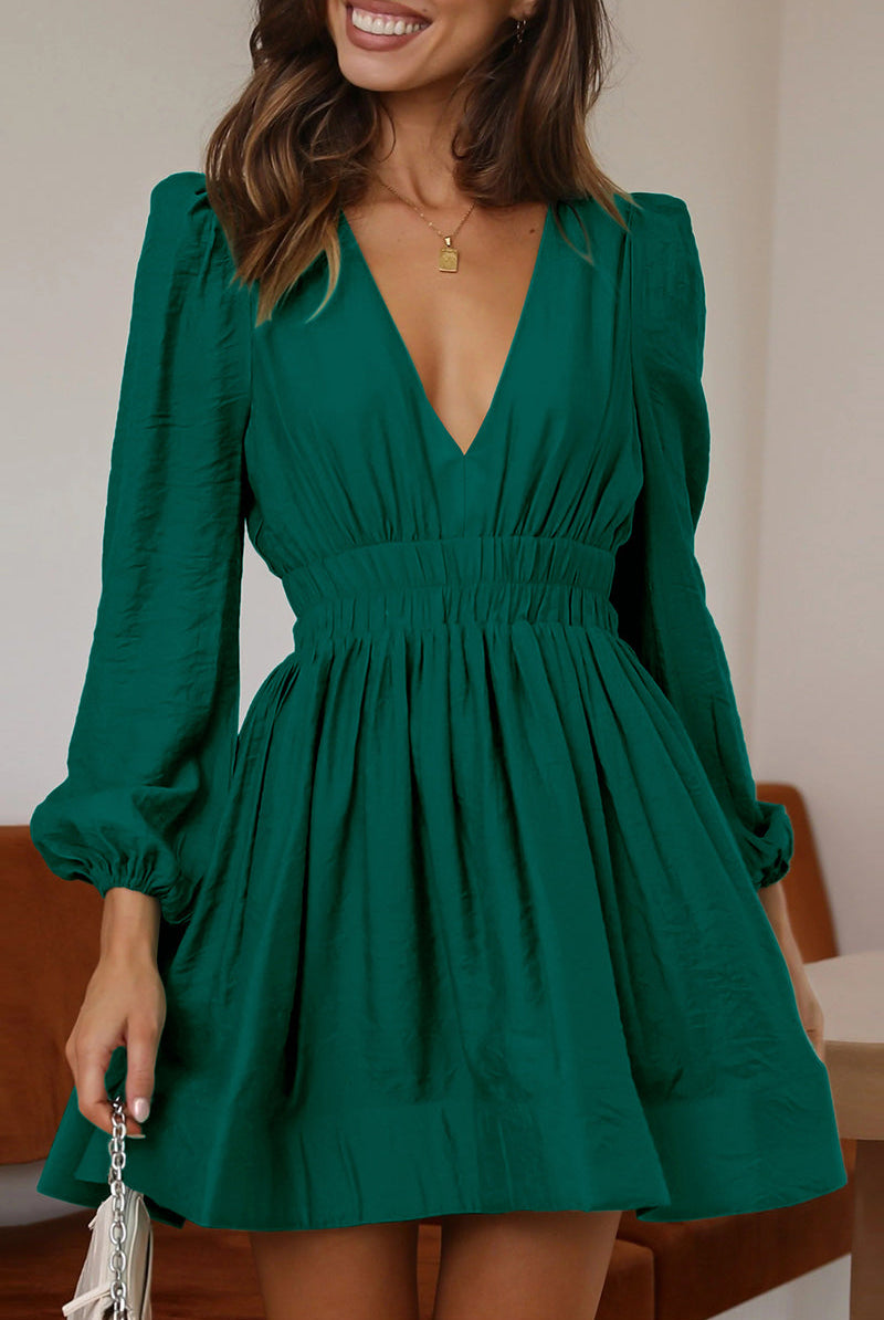Black Nova mini dress by Lumina Vancouver featuring a V-neck and puff sleeves, shown on a model.