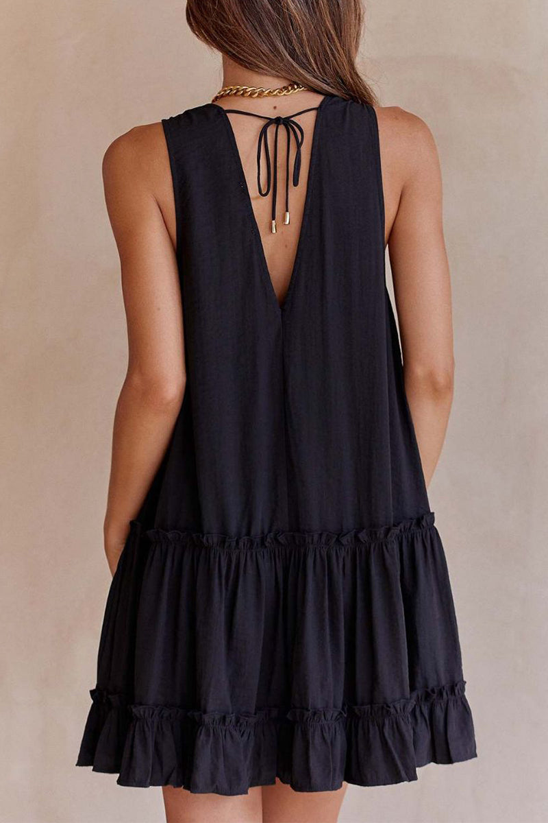 Black Lumina Vancouver Emer sleeveless ruffle mini dress with deep V-neck, styled for a chic, fashionable look.