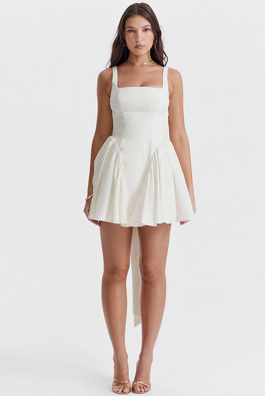 White Lumina Wear Quilla mini dress with spaghetti straps, shown on a mannequin, highlighting its slim fit and stylish design.