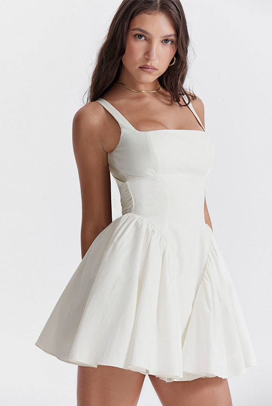 White Lumina Wear Quilla mini dress with spaghetti straps, shown on a model, featuring a fitted silhouette and stylish design.