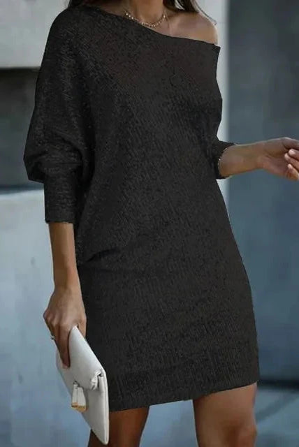 Black Olwen mini dress by Lumina Wear featuring sequins and a round neckline, shown on a model against a neutral background.