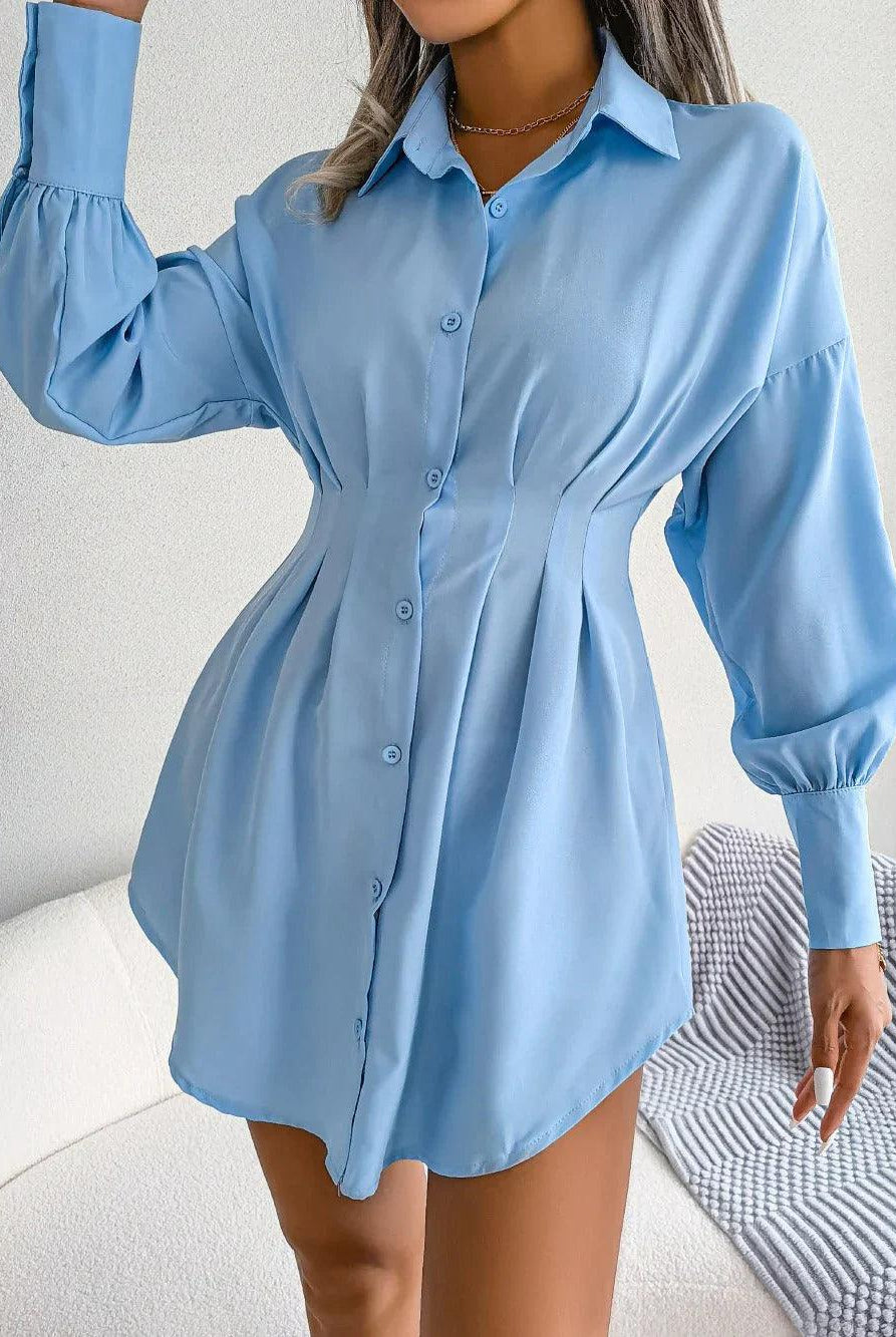 Dark green Nova Lumina tailored mini shirtdress displayed on a hanger, showcasing its structured design and classic style.