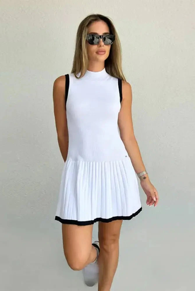 Black Nova sleeveless pleated mini dress by Lumina Vancouver, featuring a fitted bodice and stylish pleats for a chic look.