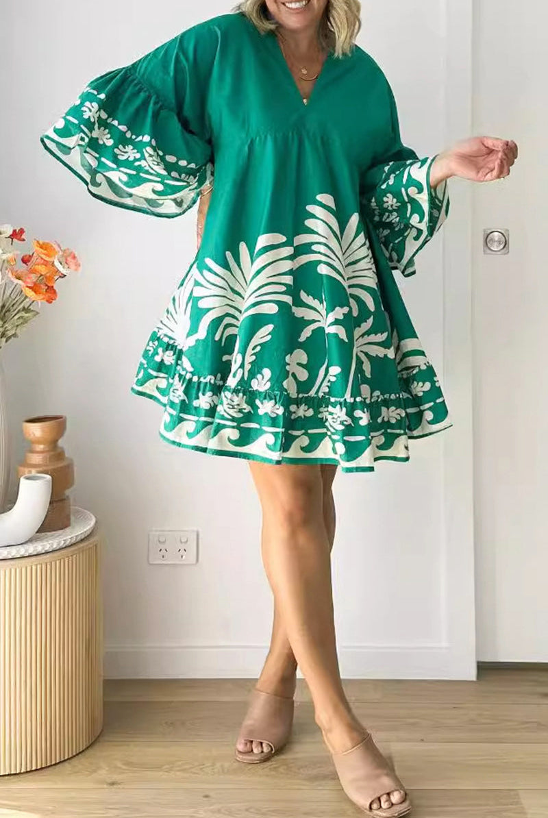 Lumina Vancouver Nova V-Neck A-Line Boho Print Mini Dress in green, displayed on a model with a flowing silhouette.