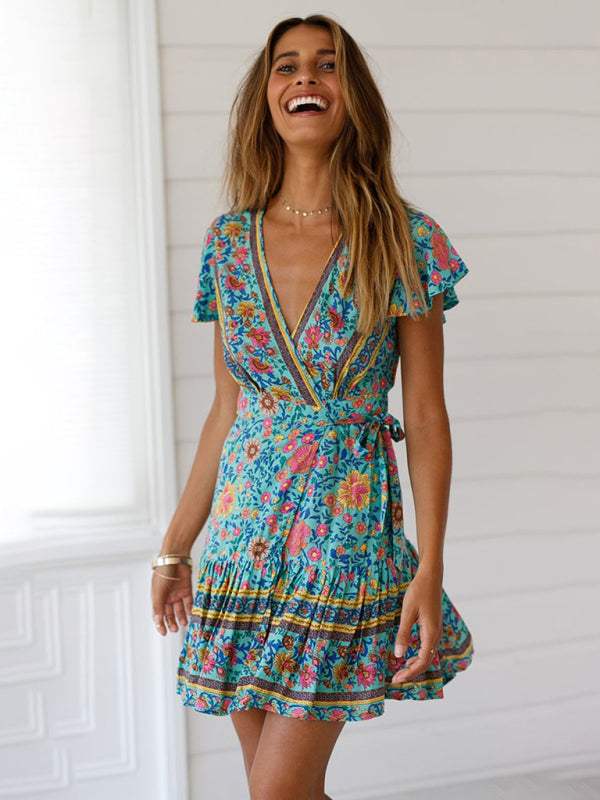 Blue floral print Gwyn wrap mini dress by Lumina Vancouver, showing a fitted waist and flowy skirt.