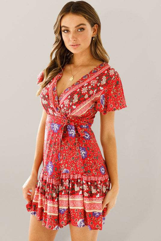 Lumina Vancouver Gwyn floral print wrap mini dress, blue with long sleeves and fitted waist, styled for casual or semi-formal wear.