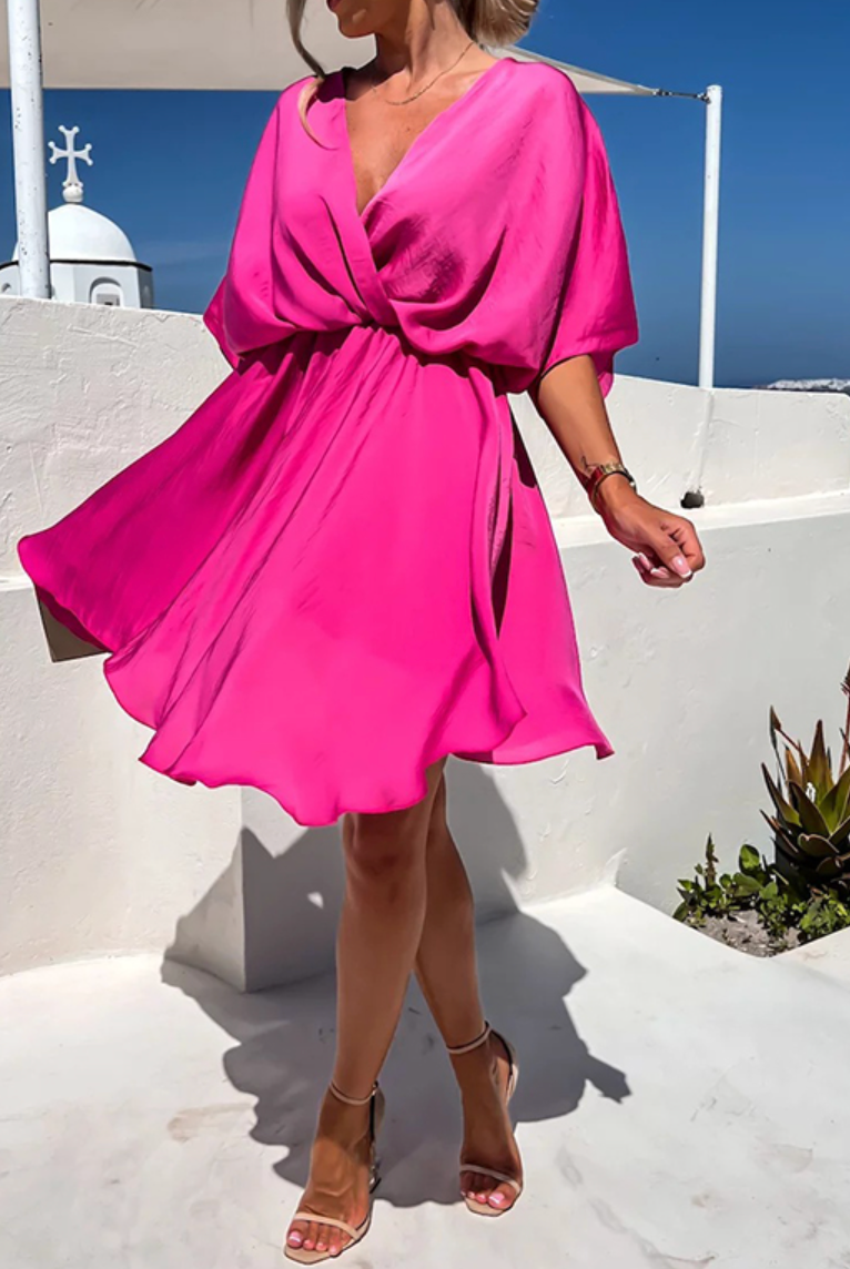 Pink Nova wrap dress by Lumina Wear featuring a V-neck and short sleeves, styled as a chic mini dress.