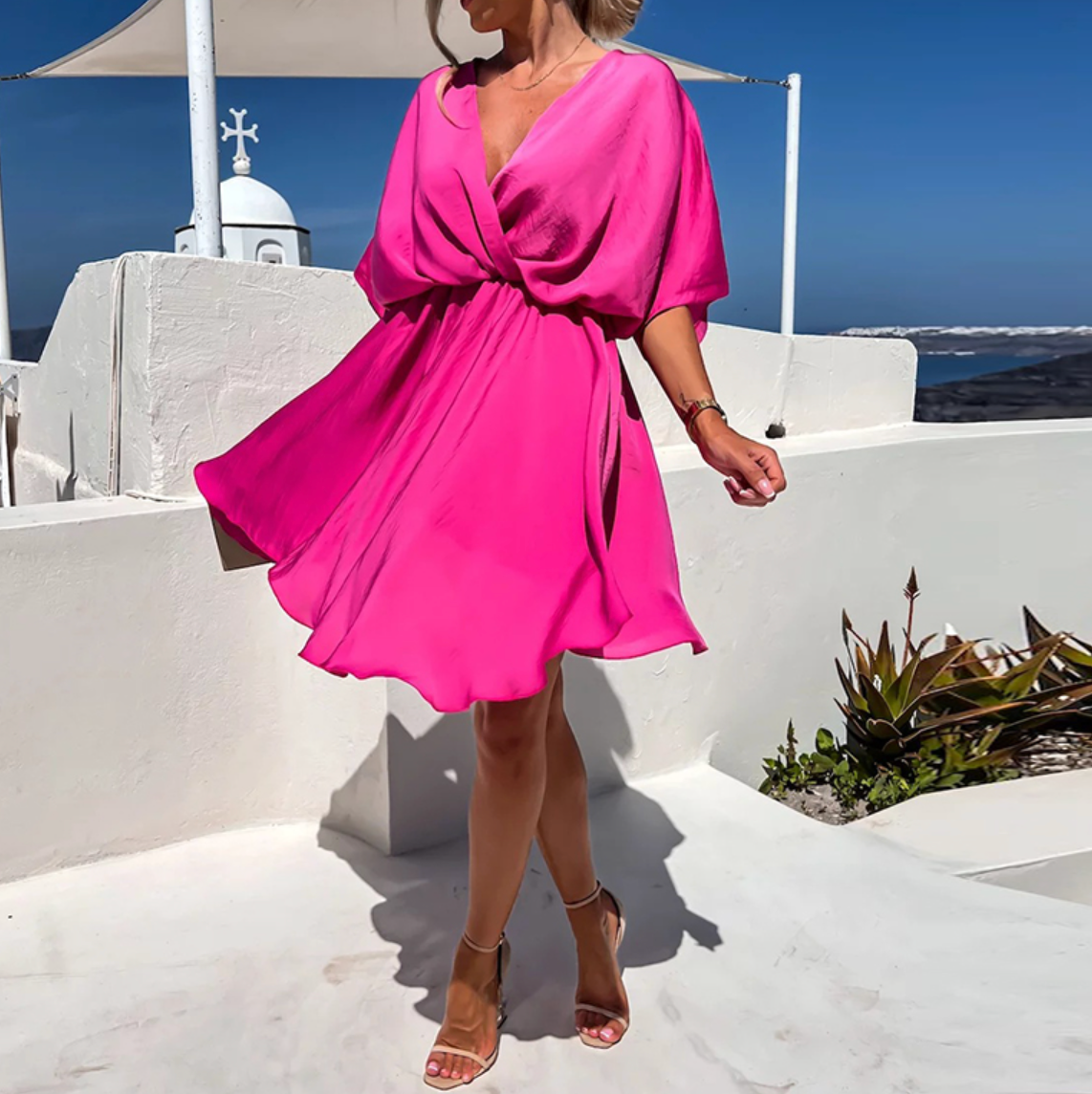 Pink Nova wrap dress by Lumina Wear featuring a V-neck and short sleeves, styled as a chic mini dress.