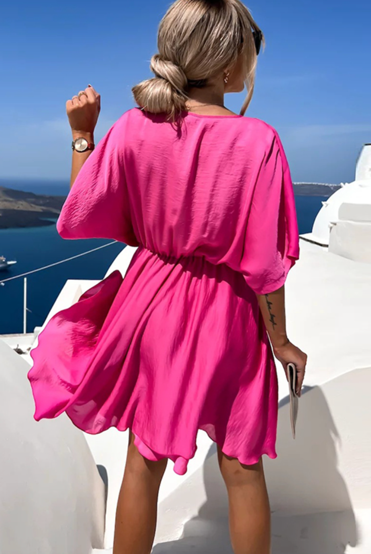 Pink Nova Wrap Dress by Lumina Wear featuring a V-neck and short sleeves, perfect for casual or semi-formal occasions.