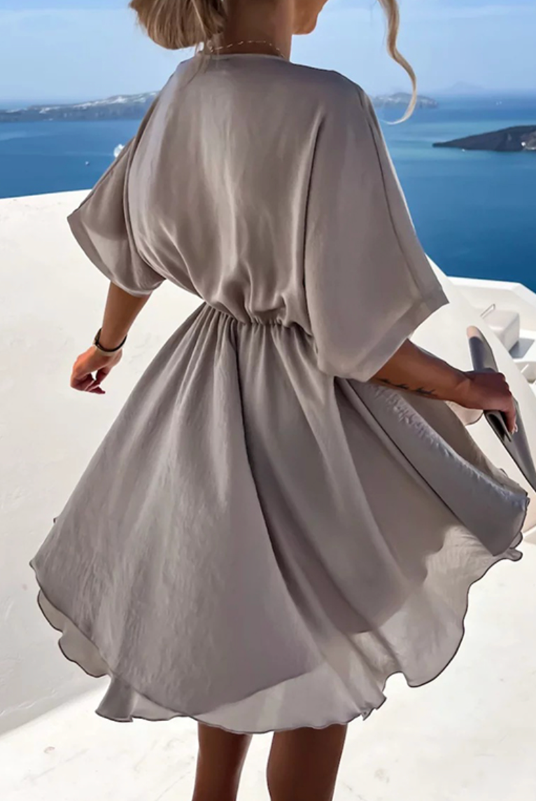 Pink Nova Wrap Dress by Lumina Wear featuring a V-neck and short sleeves, styled as a chic mini dress.