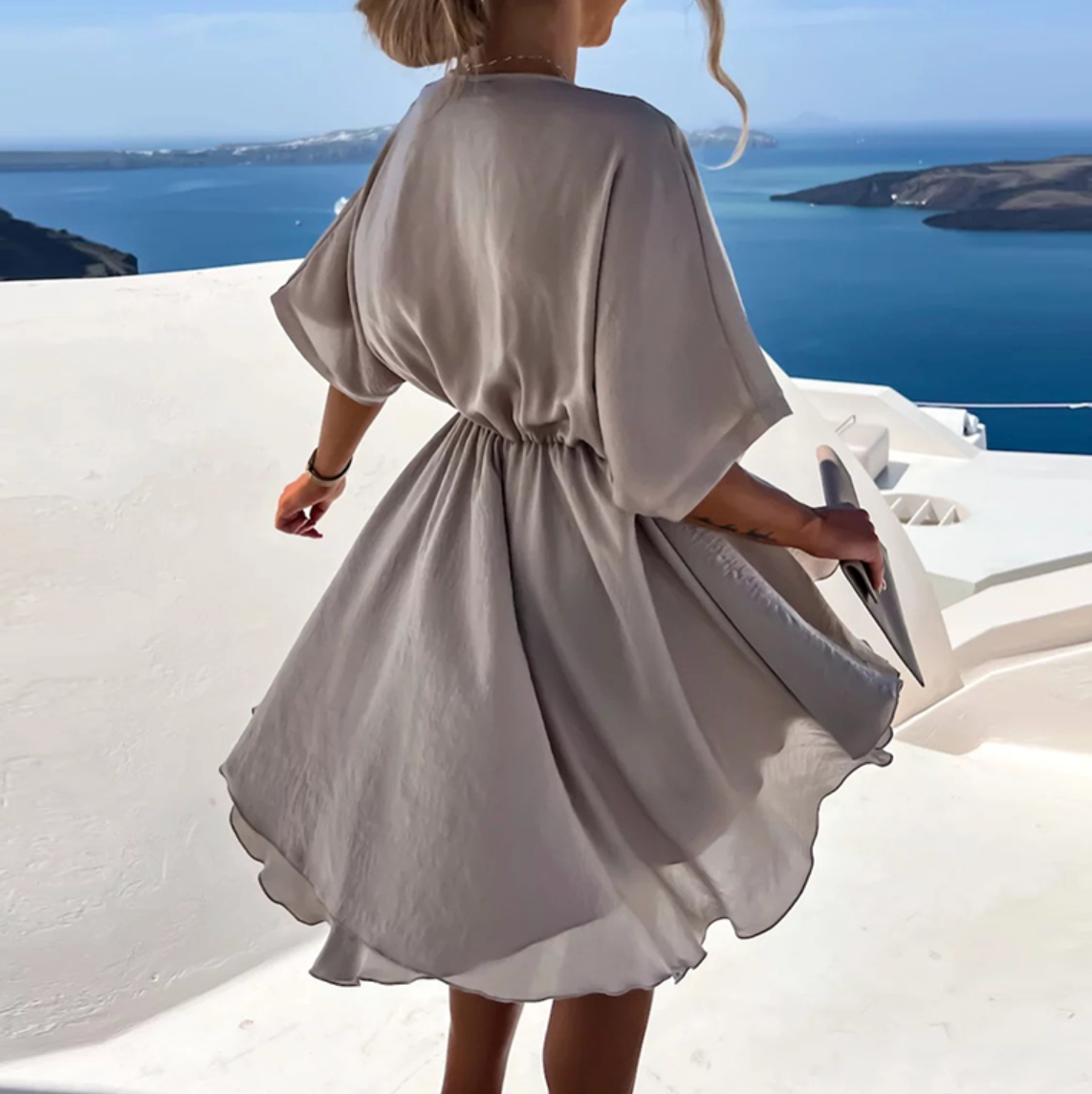 Pink Nova Wrap Dress by Lumina Wear featuring a V-neck and short sleeves, styled as a chic mini dress.
