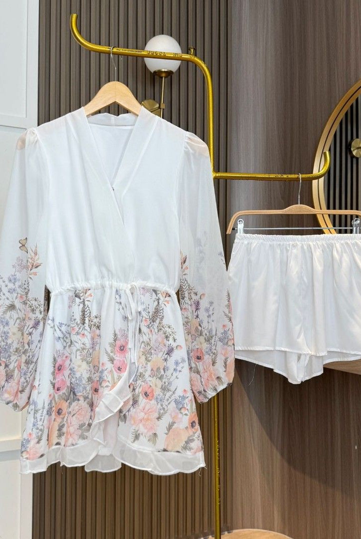 Lumina Wear Faustina floral V-neck mini dress in white, featuring a delicate floral pattern and a stylish V-neck design.