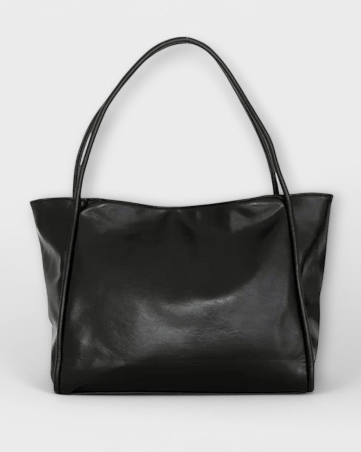Black Olivia Lumina tote bag featuring a minimalist design and spacious interior, made by Lumina Wear.