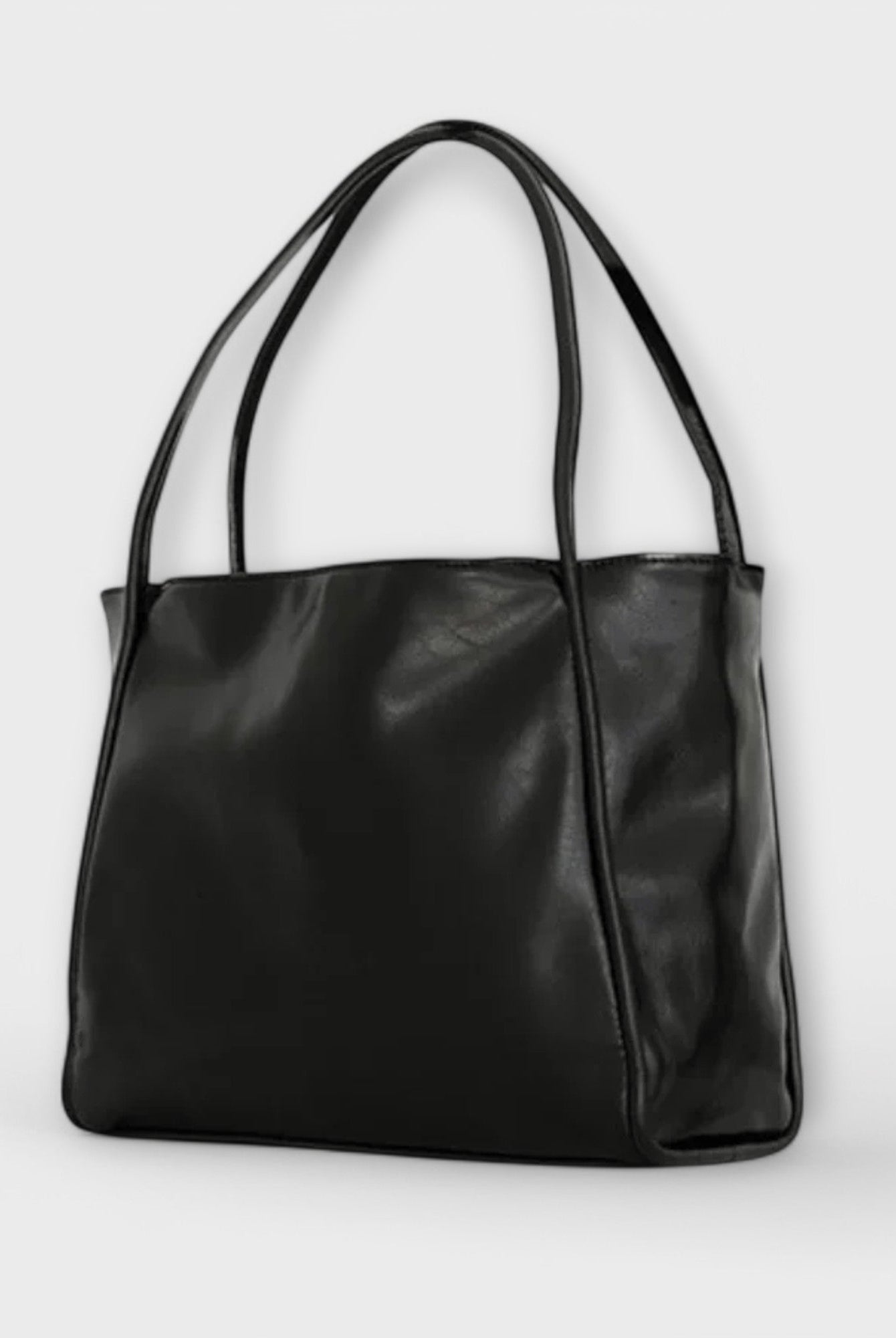 Black Olivia tote bag by Lumina Wear, featuring a spacious minimalist design and sleek silhouette for everyday use.