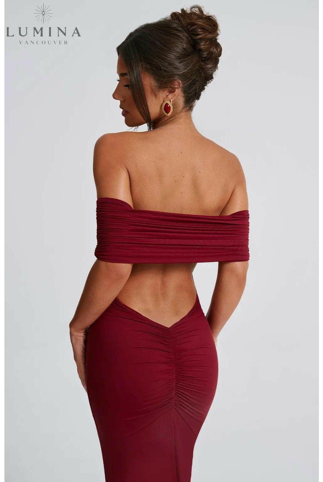 Black Olympia Lumina Wear backless maxi dress with elegant design, perfect for wedding guests, shown on a size XS mannequin.