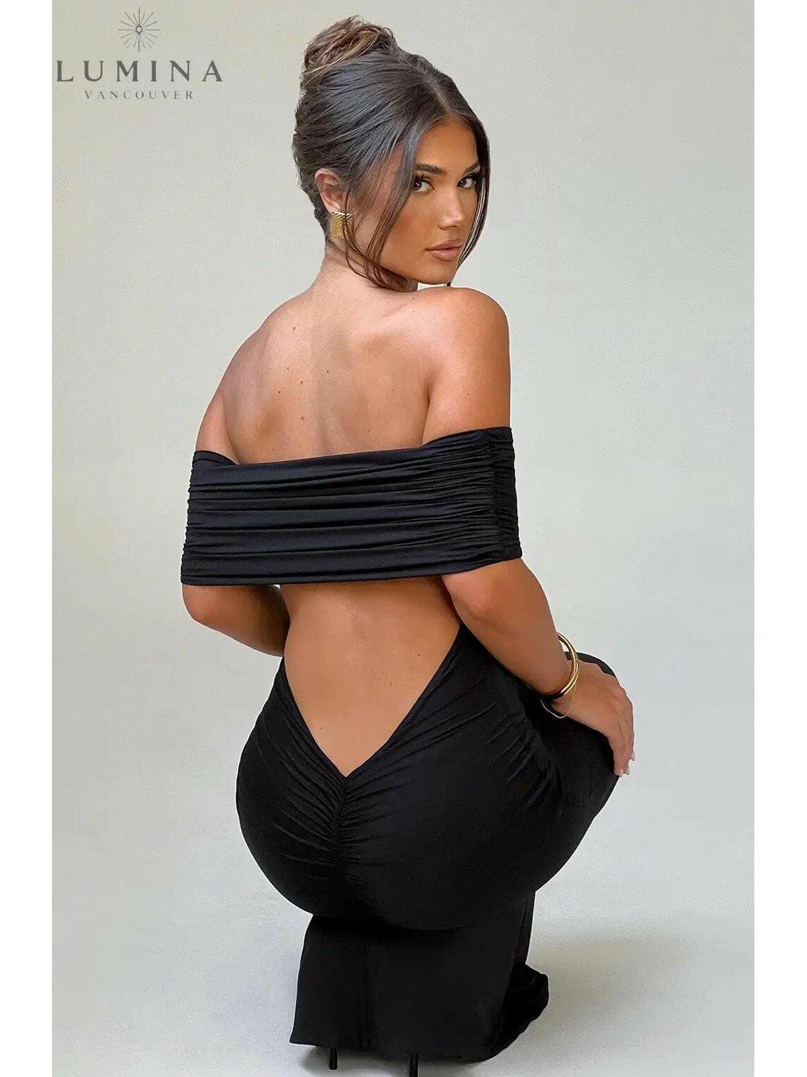Black Olympia Elegant Backless Maxi Dress by Lumina Vancouver, perfect for wedding guest attire, featuring a flowing silhouette.