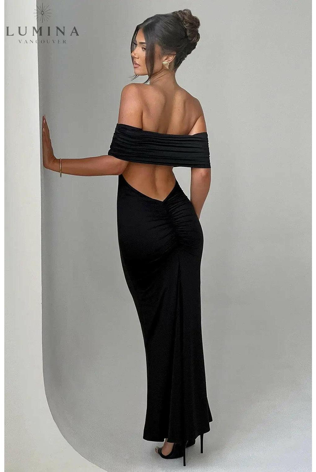 Black Olympia Lumina Wear backless maxi dress with elegant design, perfect for wedding guests and formal occasions.