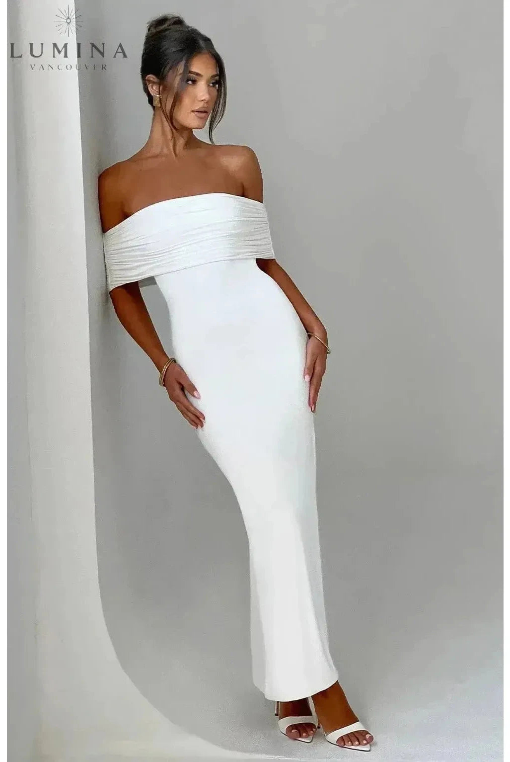 Black Olympia Elegant Backless Maxi Dress by Lumina Wear, featuring a flowy silhouette and stylish open back for wedding guest attire.