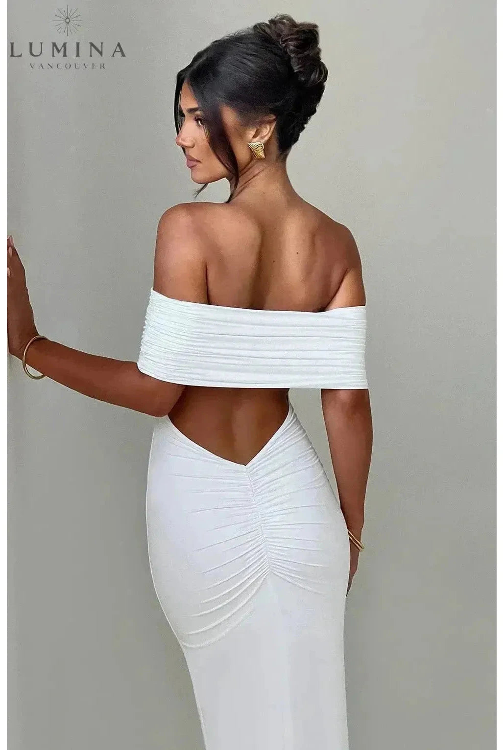 Black Olympia backless maxi dress by Lumina Wear, featuring a flowing design perfect for wedding guests and formal occasions.