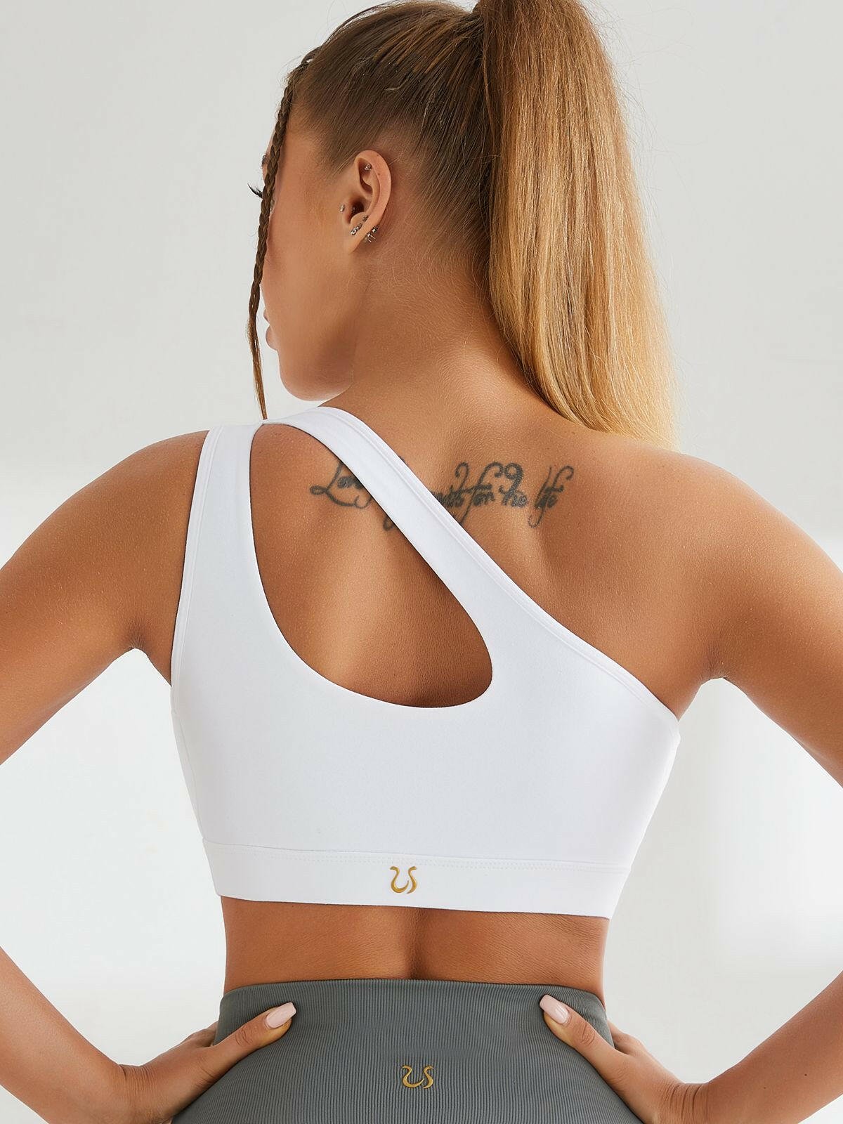 Black one-shoulder sports ankle bra from Lumina Vancouver, designed for comfortable activewear and support during workouts.