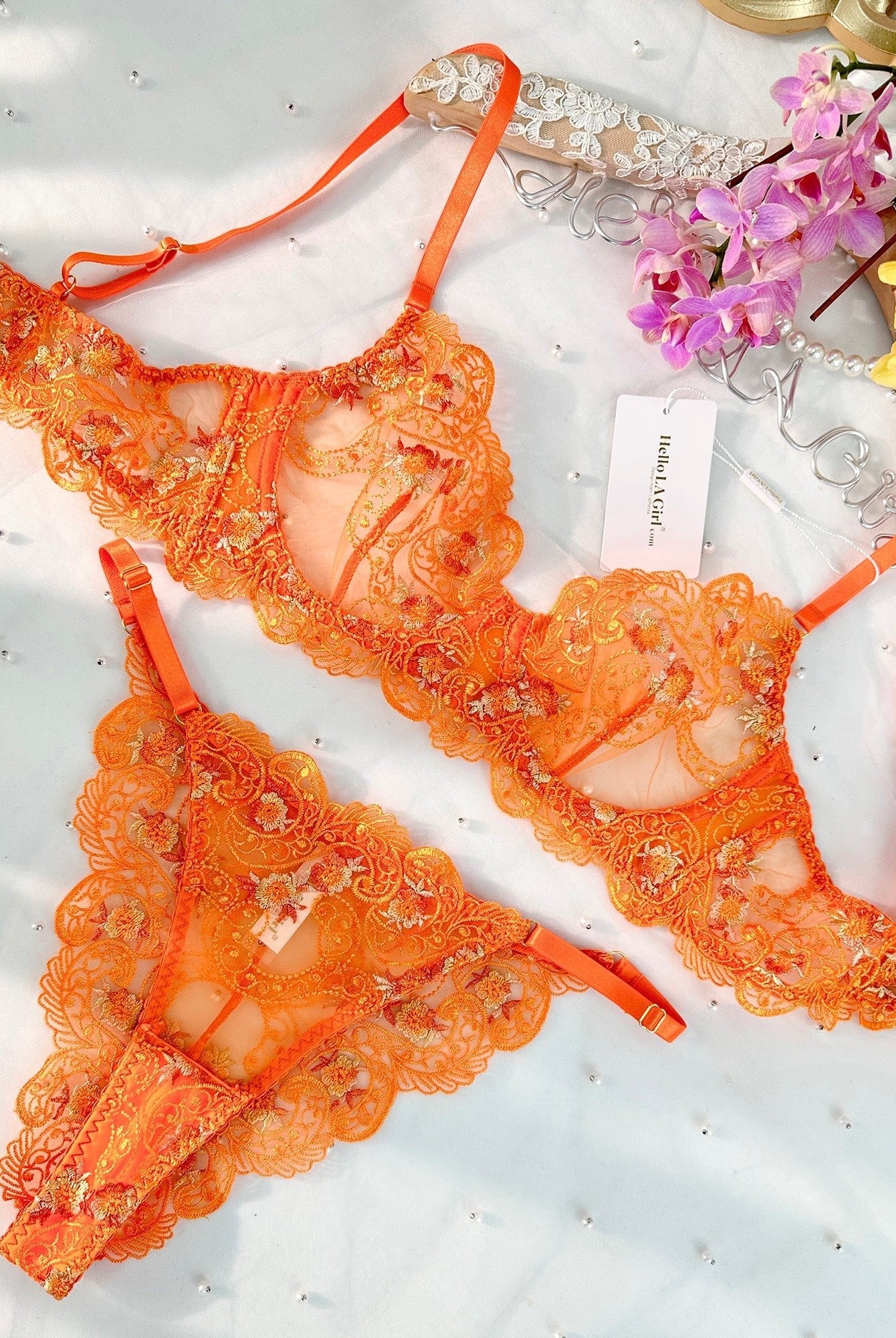 Orange floral embroidery lingerie set by Lumina Wear, includes two-piece bra and panty set with detailed floral embroidery.