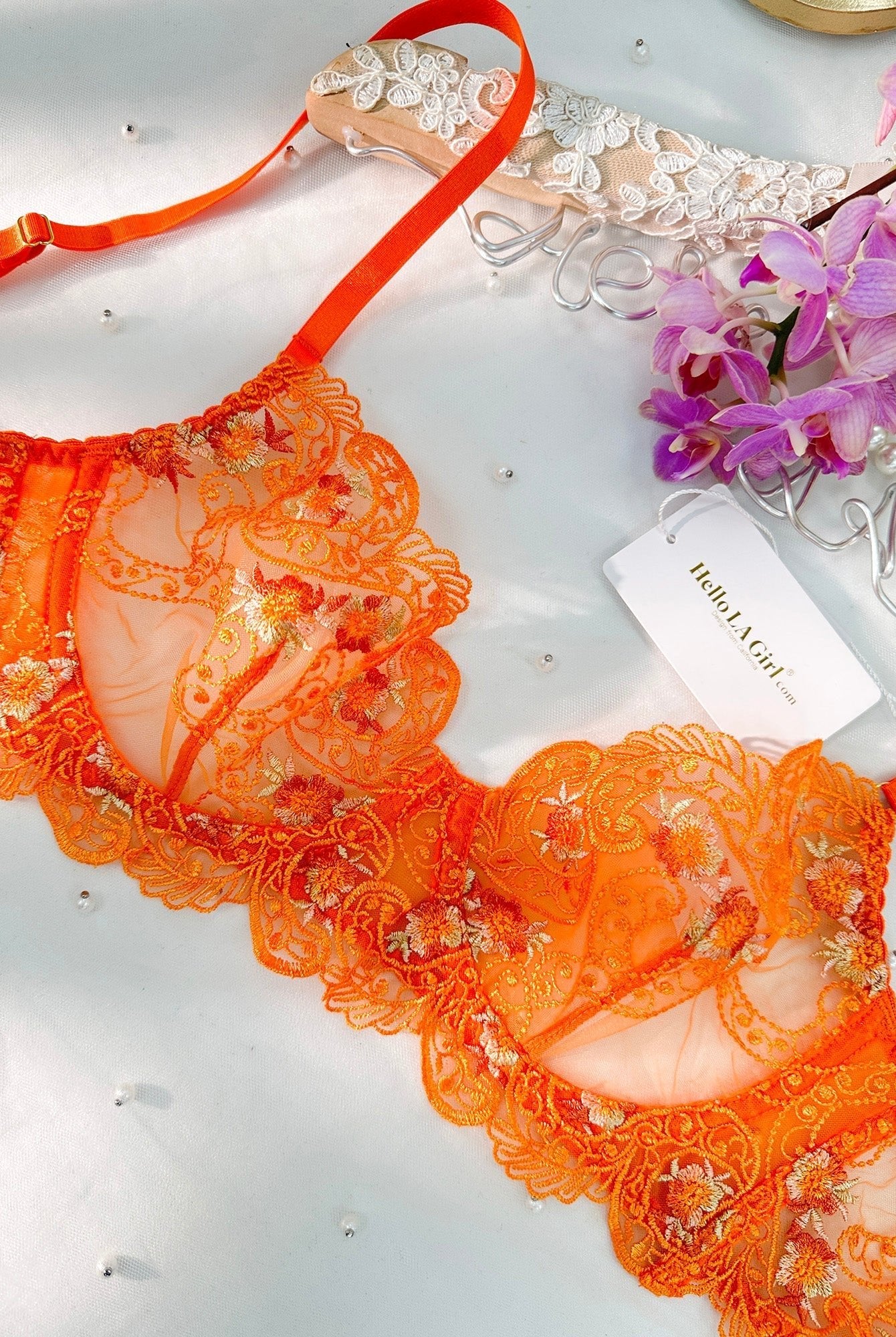 Orange floral embroidered lingerie set by Lumina Wear, featuring a matching bra and panties in a vibrant, detailed design.