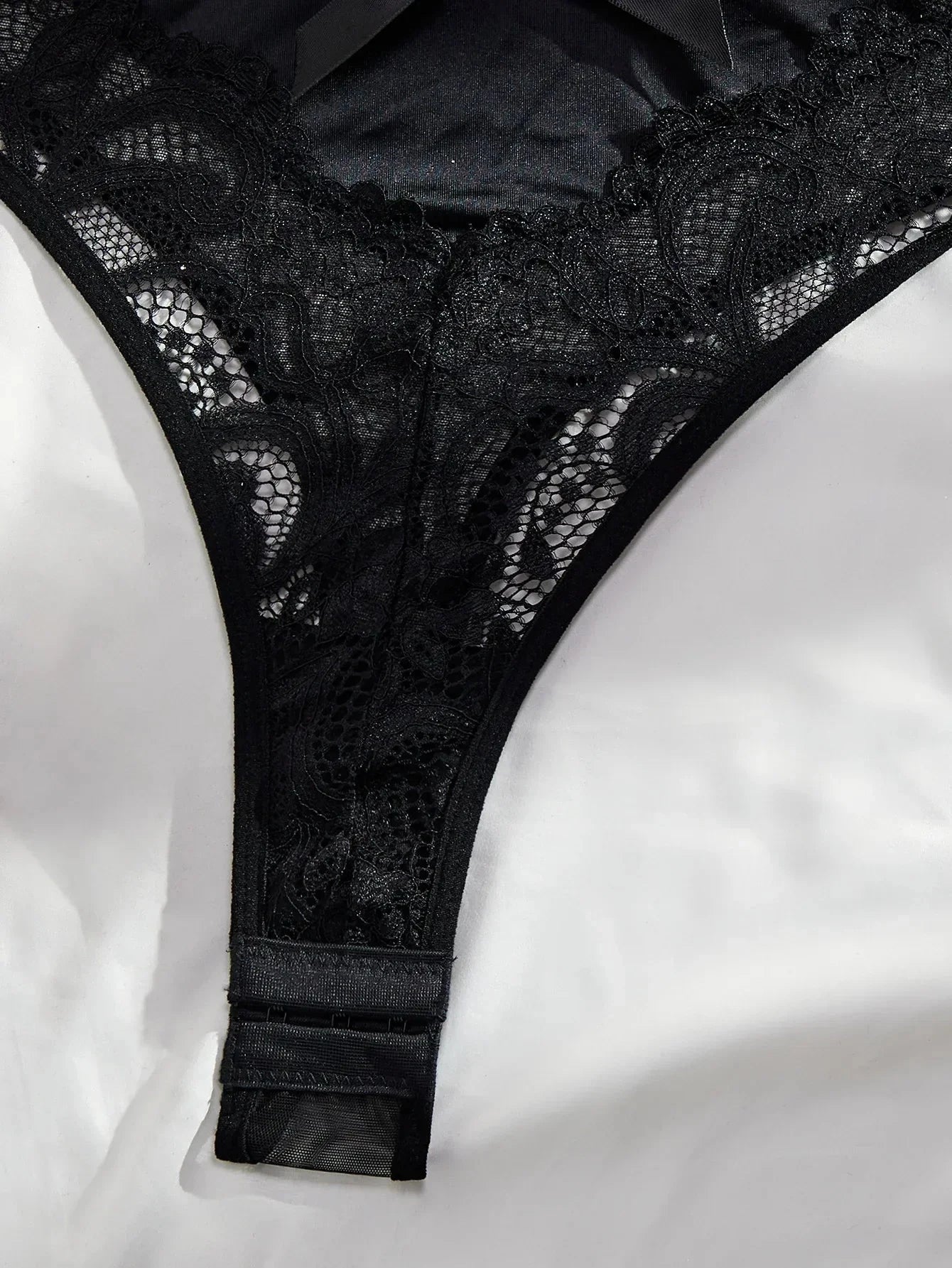 Oriana's Bodysuit by Lumina Vancouver, close-up of sleek black bodysuit with fitted design and subtle neckline detail.