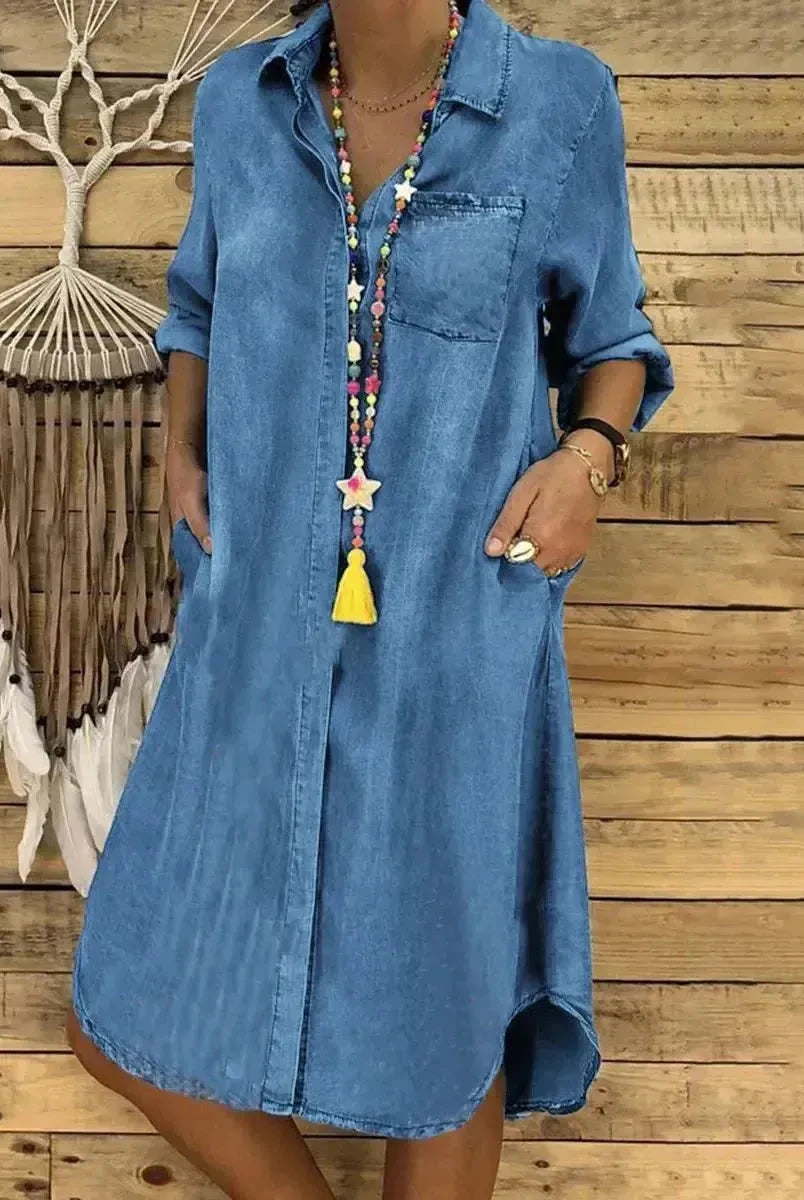 Baby blue Palmira denim long-sleeved dress by Lumina Wear with a fitted silhouette and button details, displayed on a plain background.
