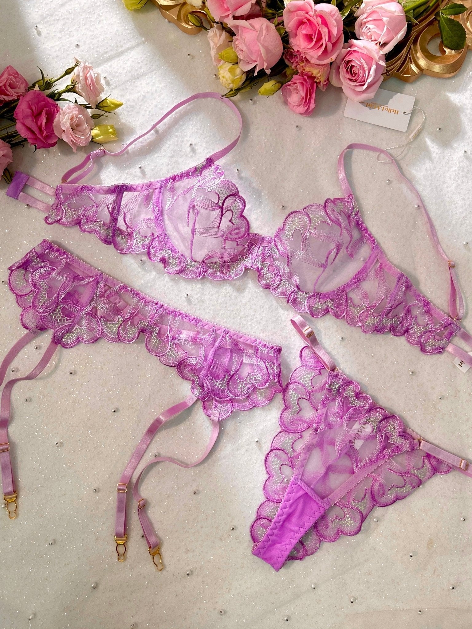 Purple embroidery lingerie set with three pieces from Lumina Vancouver, featuring bras, panties, and a matching garter belt.