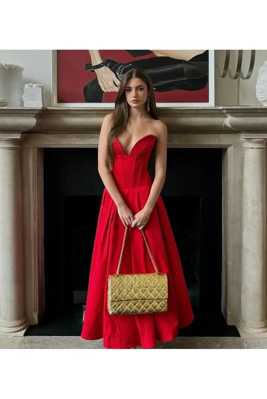 Red Adaline strapless pleated midi dress by Lumina Wear, showcasing a sleek design with a fitted bodice and flowing skirt.
