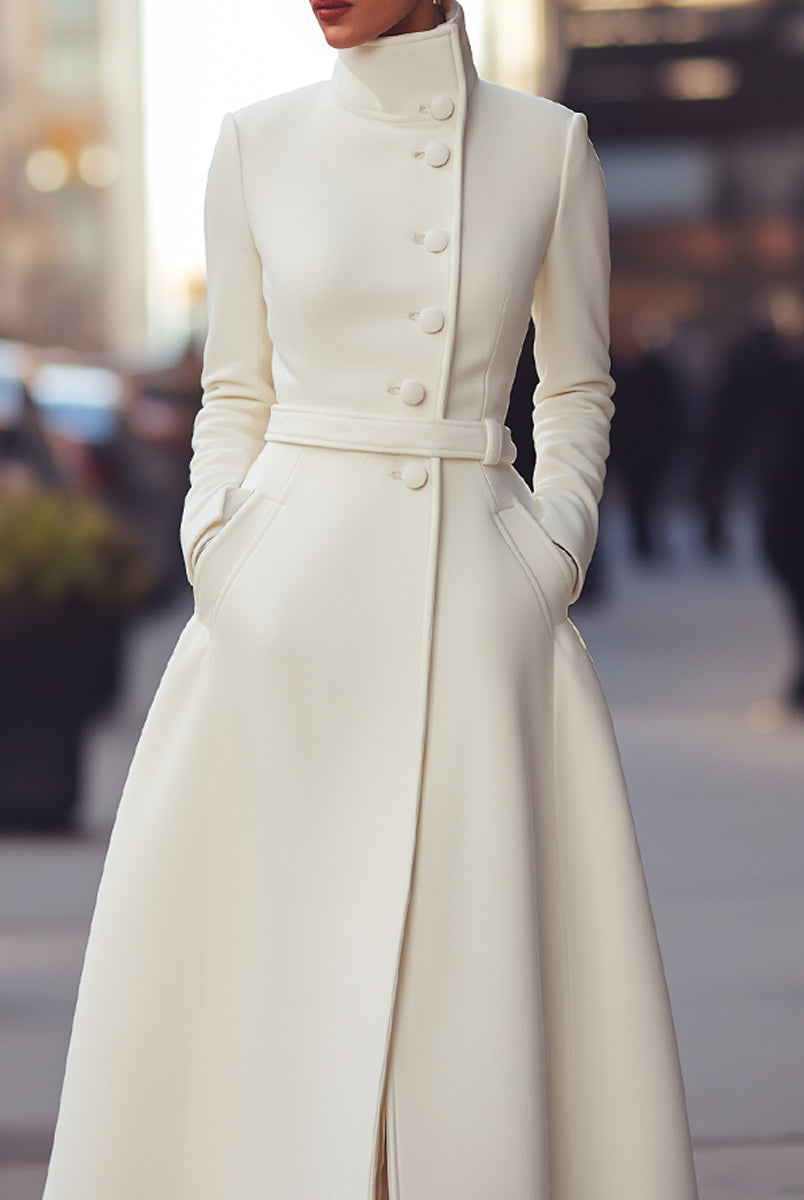 White Regina military-inspired wool coat by Lumina Vancouver shown on a model, featuring structured design and classic details.