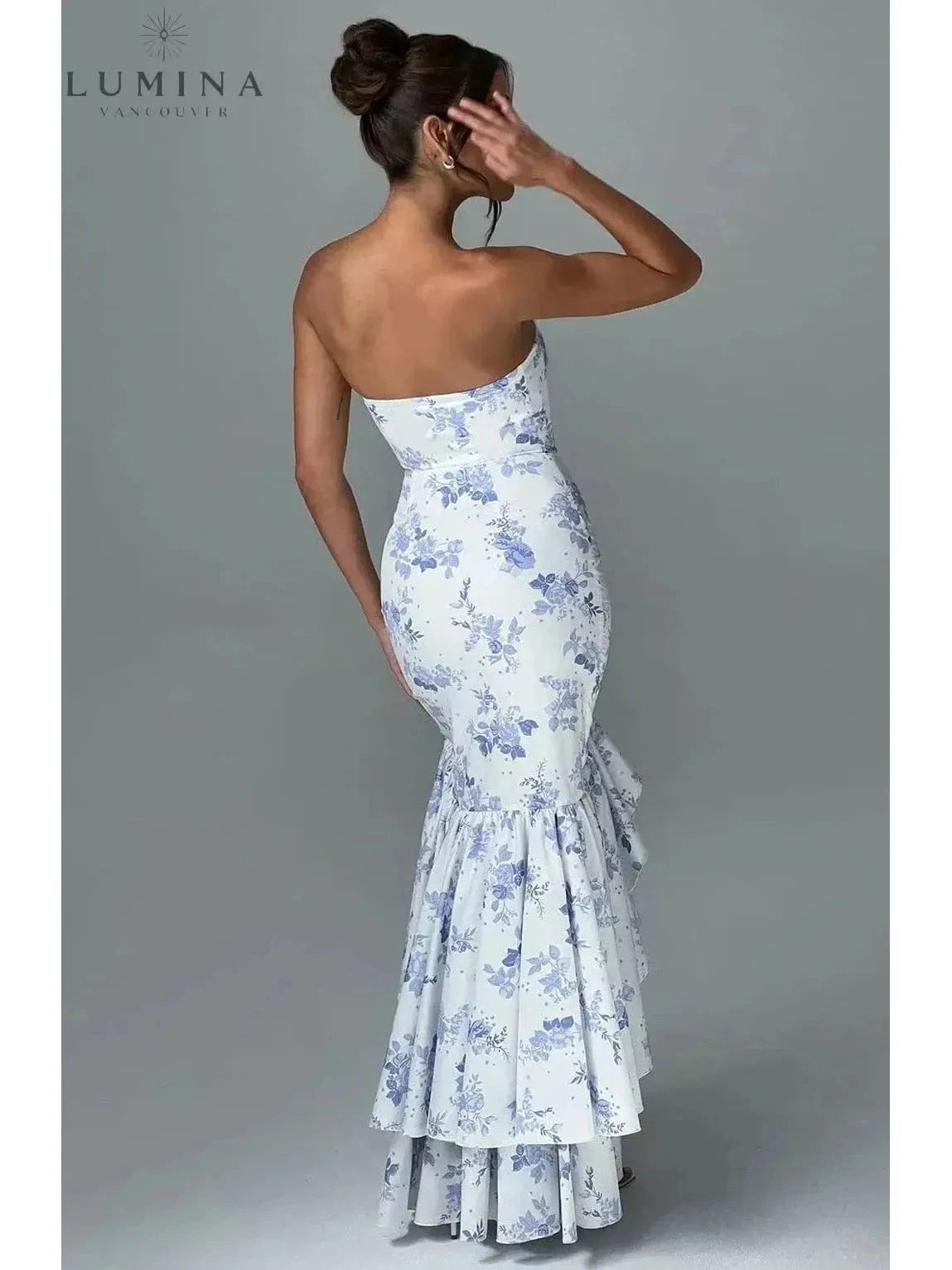 Blue floral Riviera sleeveless slit ruffle maxi dress by Lumina Wear, perfect for wedding guests, shown on a model.