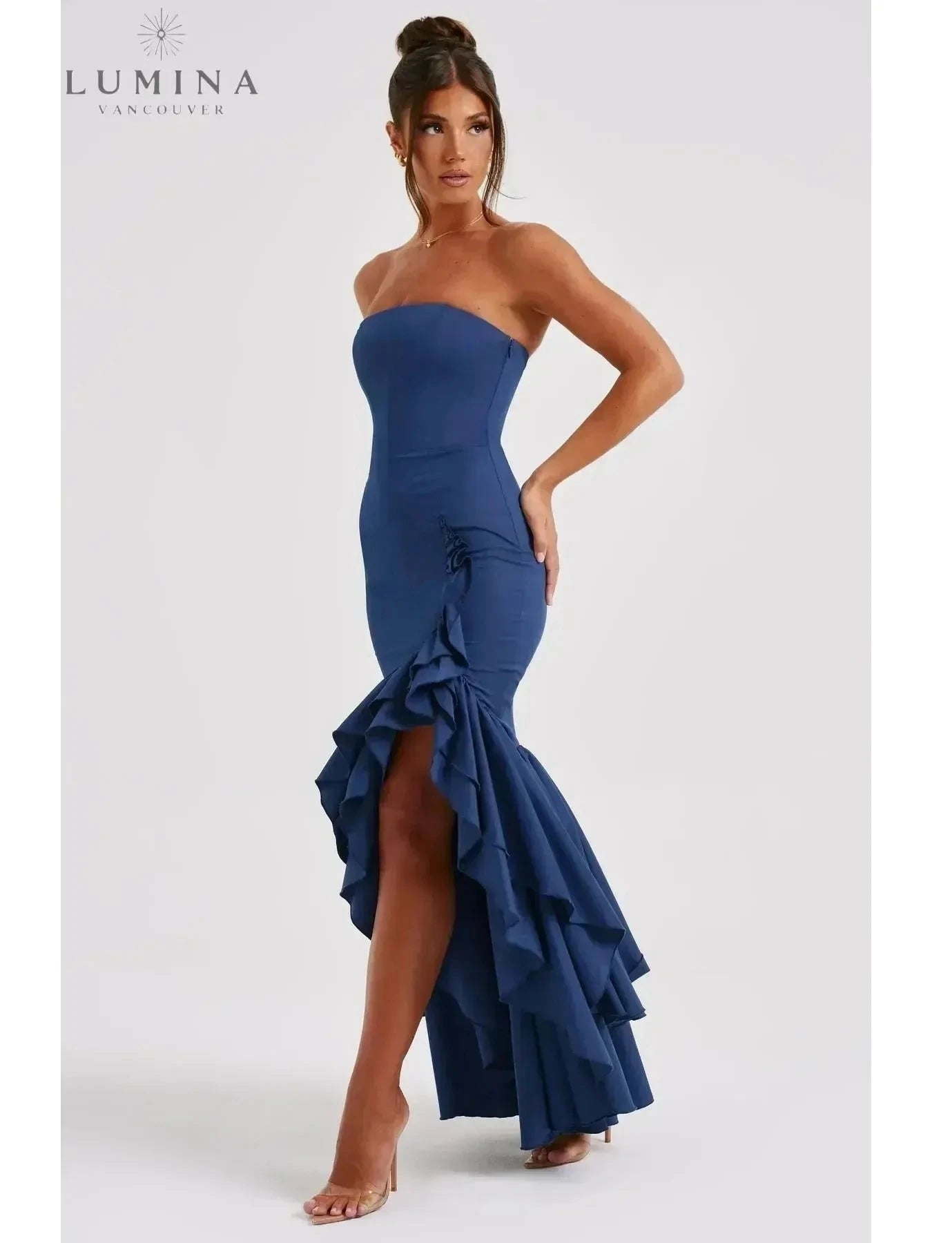 Blue floral Riviera sleeveless slit ruffle maxi dress by Lumina Wear, perfect for wedding guests, shown on a model.