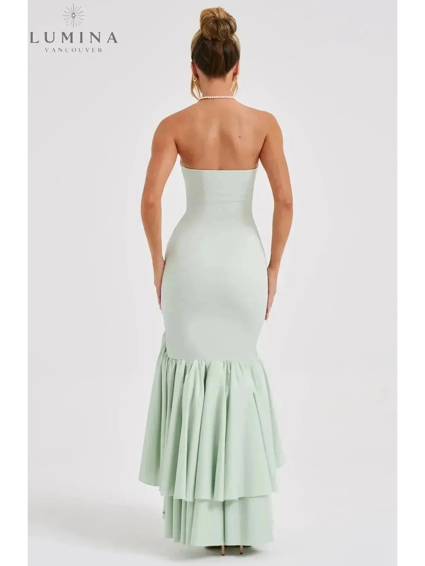 Blue floral sleeveless slit ruffle maxi dress by Lumina Wear, perfect for wedding guests, shown on a model.