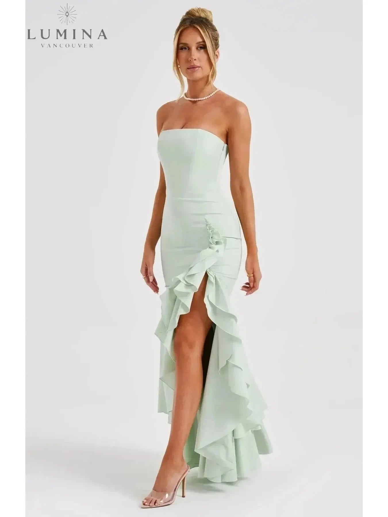 Blue floral sleeveless slit ruffle maxi dress by Lumina Wear, perfect for wedding guests, featuring elegant flowy fabric and ruffle details.