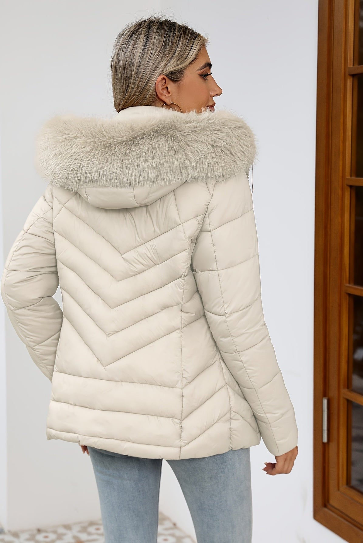 Black women's Ruby quilted puffer jacket with faux-fur hood by Lumina Wear, featuring a cozy, insulated design and stylish fit.