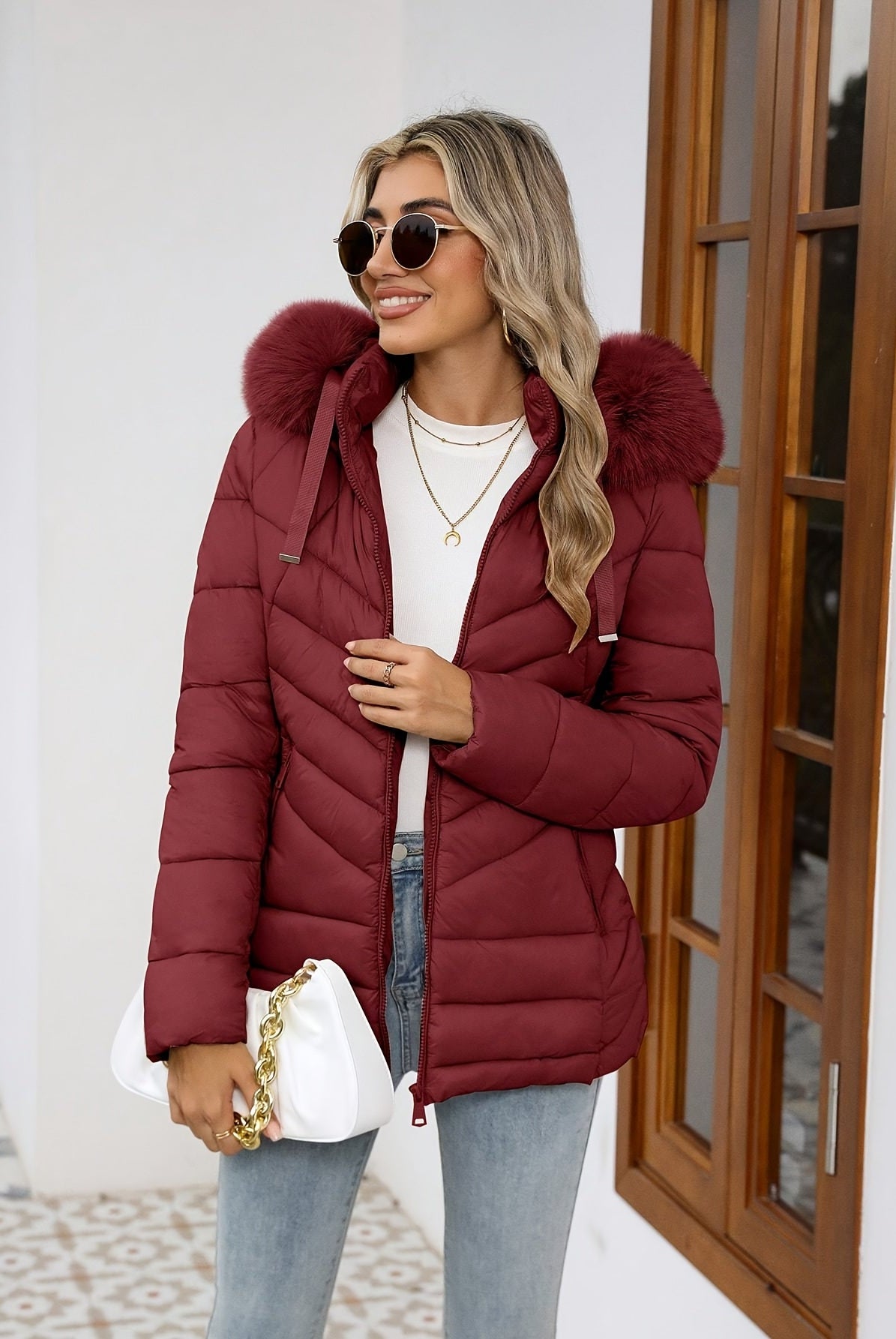 Black women's Ruby quilted puffer jacket with faux-fur hood from Lumina Wear, featuring a cozy, insulated design.