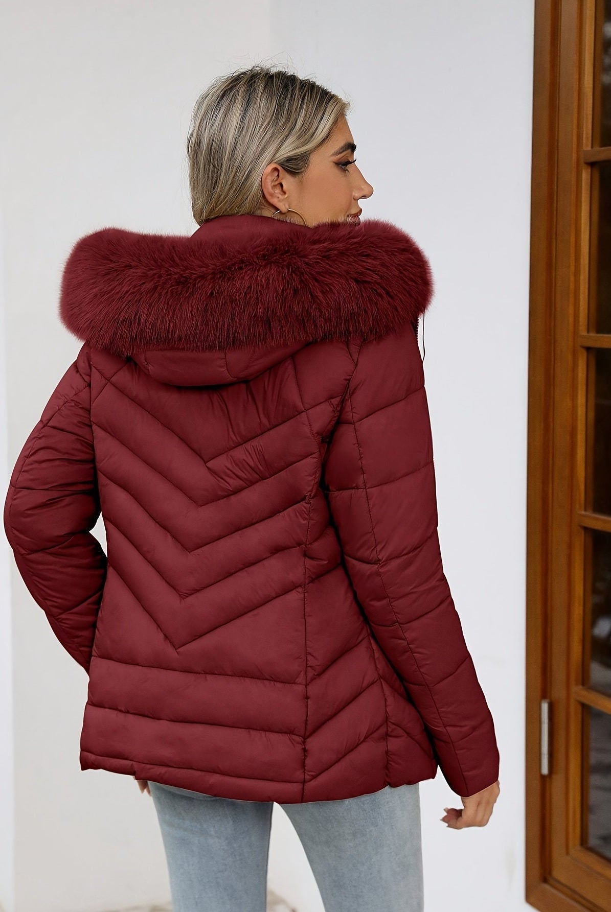 Black women's Ruby cozy quilted puffer jacket with faux-fur hood by Lumina Wear, featuring a fitted style and plush collar.