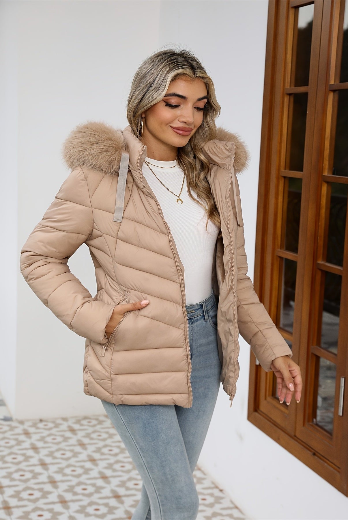 Black Lumina Wear Ruby cozy quilted puffer jacket with faux-fur hood, designed for women, featuring a warm, stylish winter coat.