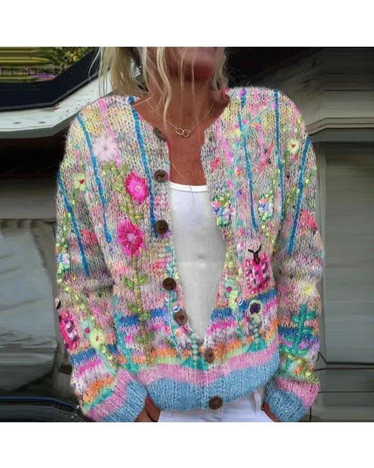 Blue Sanne cardigan by Lumina Wear featuring an elegant floral print, displayed on a hanger against a neutral background.