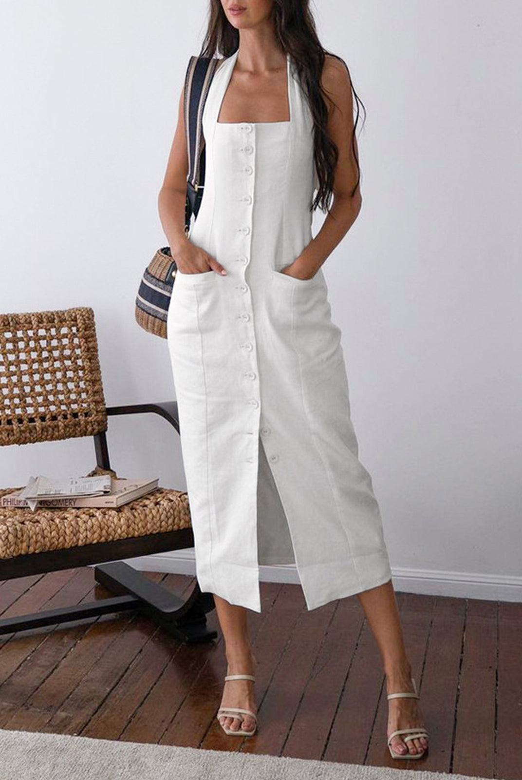 White Suvi halter neck maxi dress by Lumina Wear, featuring a flowing design and elegant halter neckline.