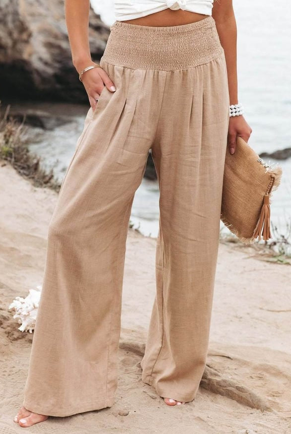 White wide-leg trousers from Lumina Wear featuring a breathable fabric and elastic waistband, styled for a relaxed fit.